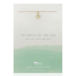 Lucky Feather Starfish Necklace on display card reading "Celebrity of the sea you're a shining star". Gold starfish charm on nylon cord.