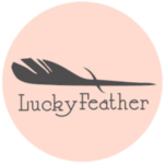 Lucky Feather Logo in black with feather on top of company name. Logo inside pink circle.